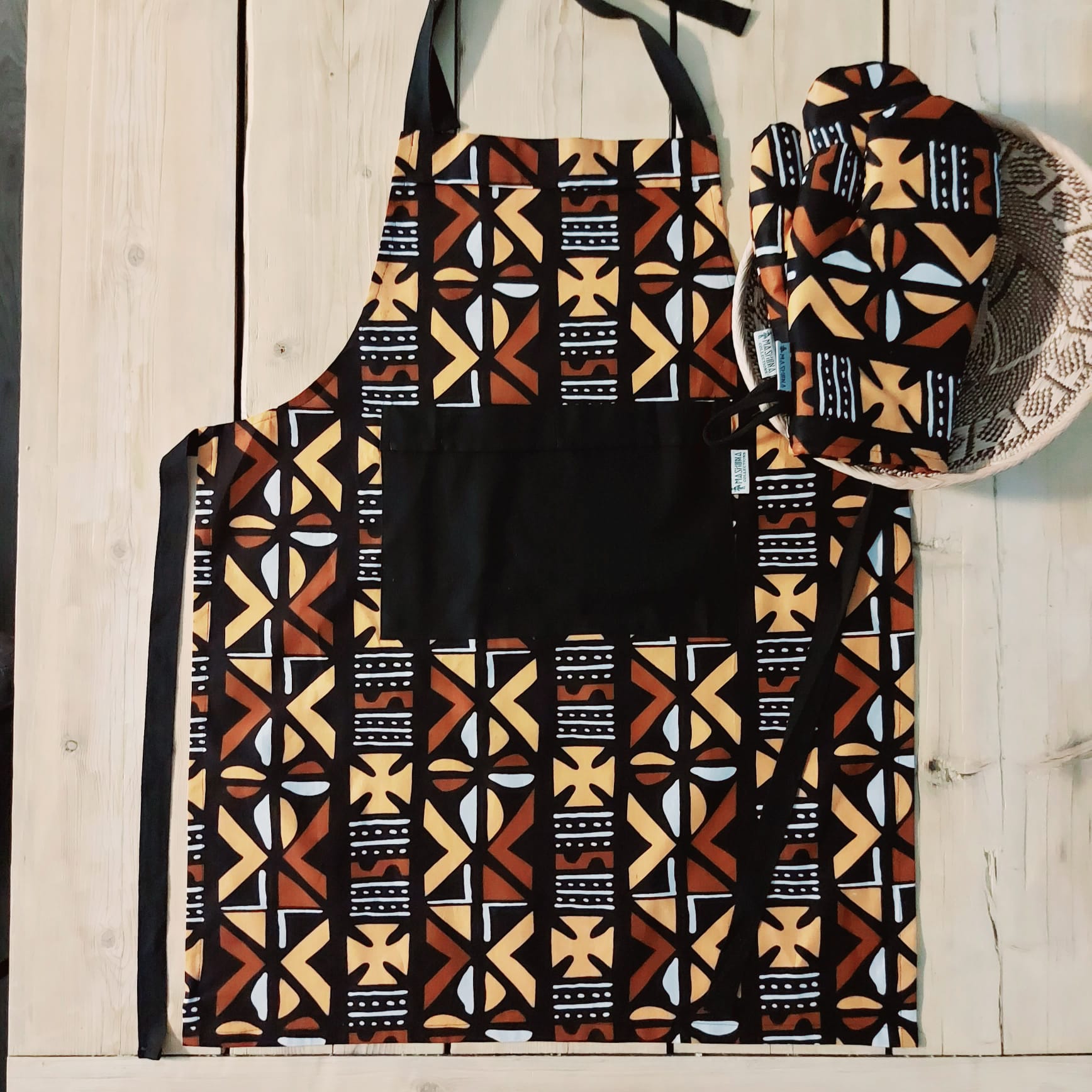 Handmade apron and matching oven gloves set featuring vibrant African print designs, showcasing quality cotton fabric.