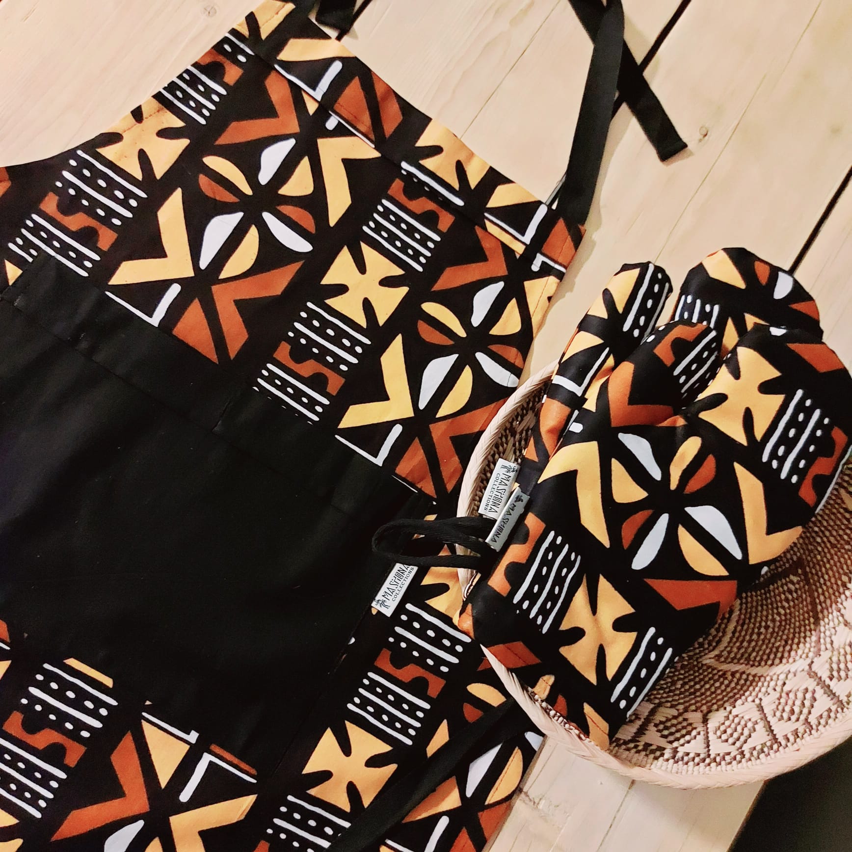 Handmade apron and matching oven gloves set featuring vibrant African print designs, crafted from 100% cotton fabric.