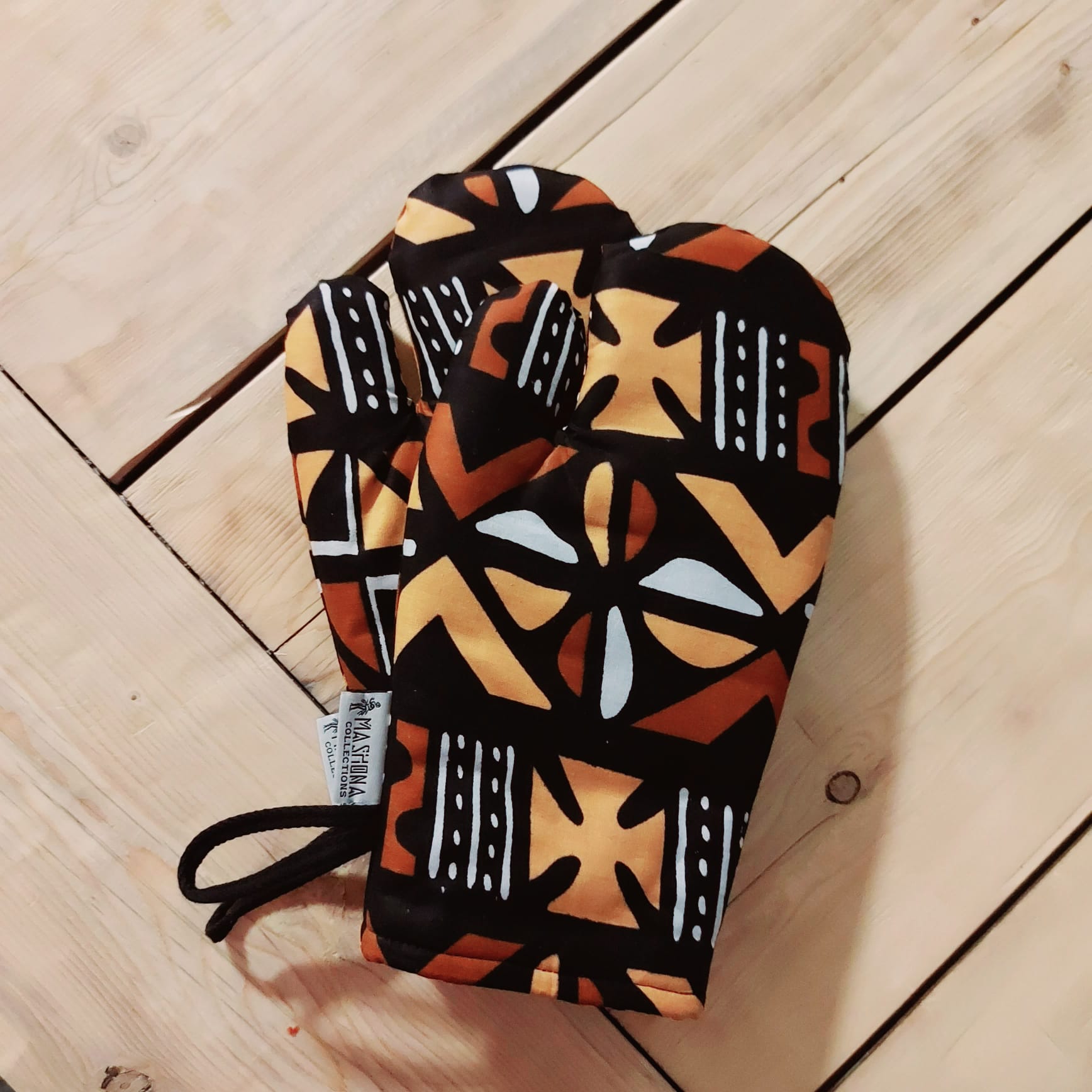 Handmade apron and matching oven gloves set featuring vibrant African print designs, crafted from 100% cotton fabric.