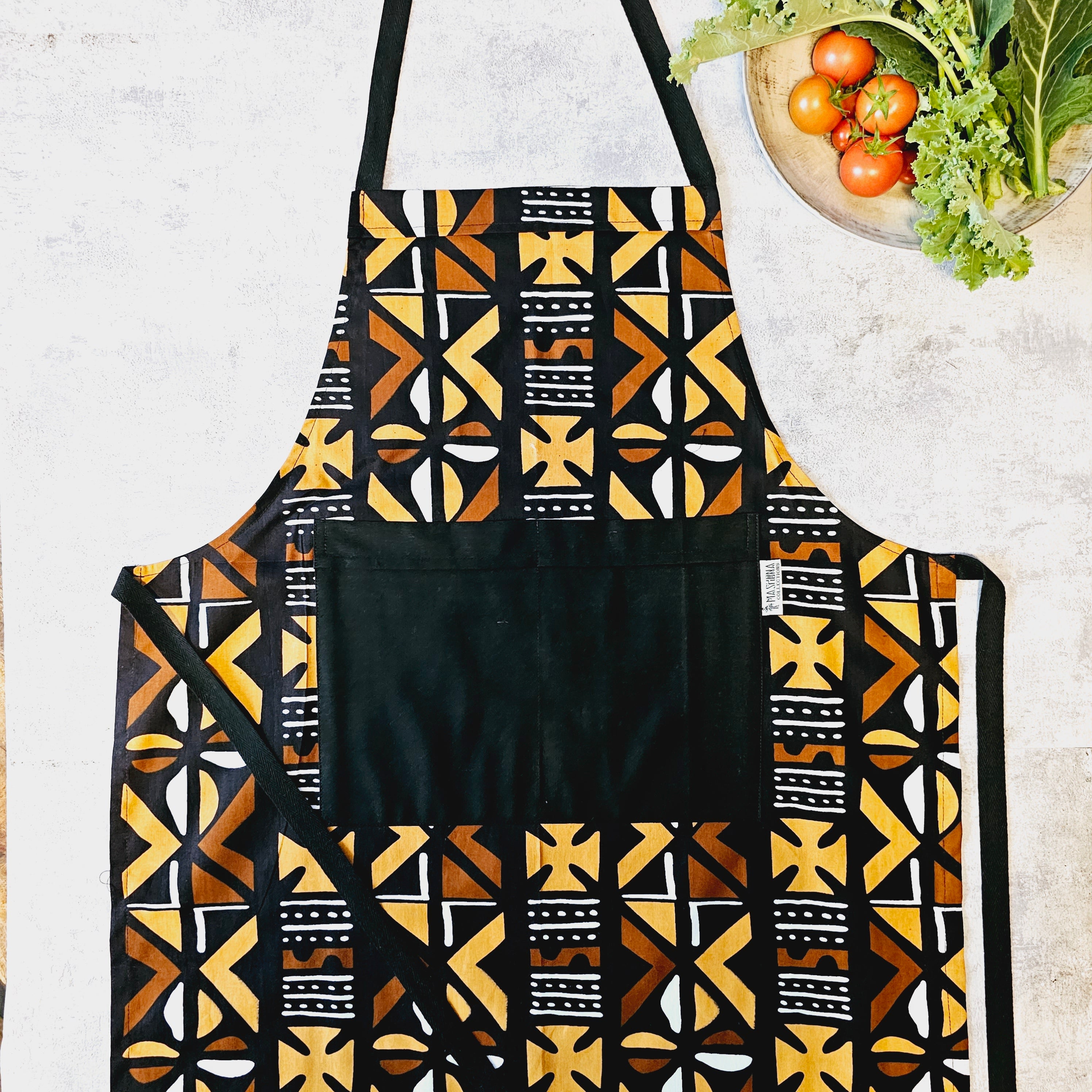 Handmade African print apron featuring vibrant Bogolan design, made from 100% cotton with a pocket.