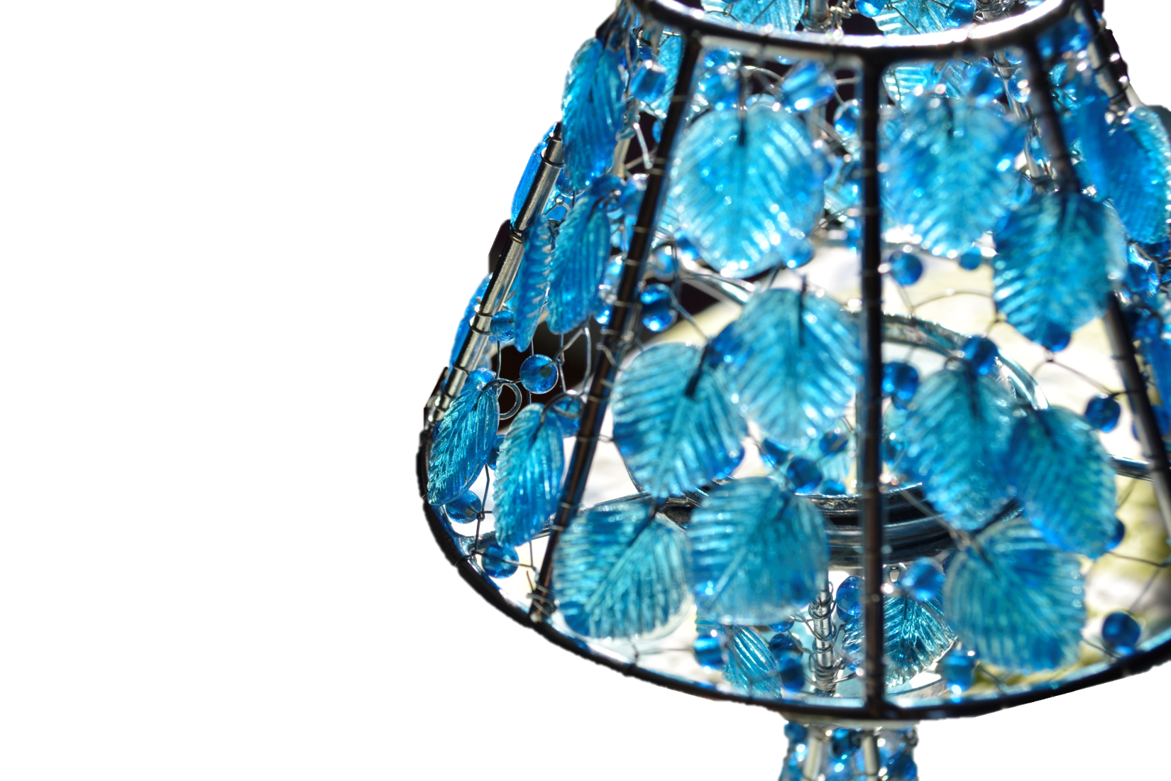 A beautifully handcrafted colored glass tea light candle holder featuring floral motifs and a sturdy spindle, radiating warm candlelight.