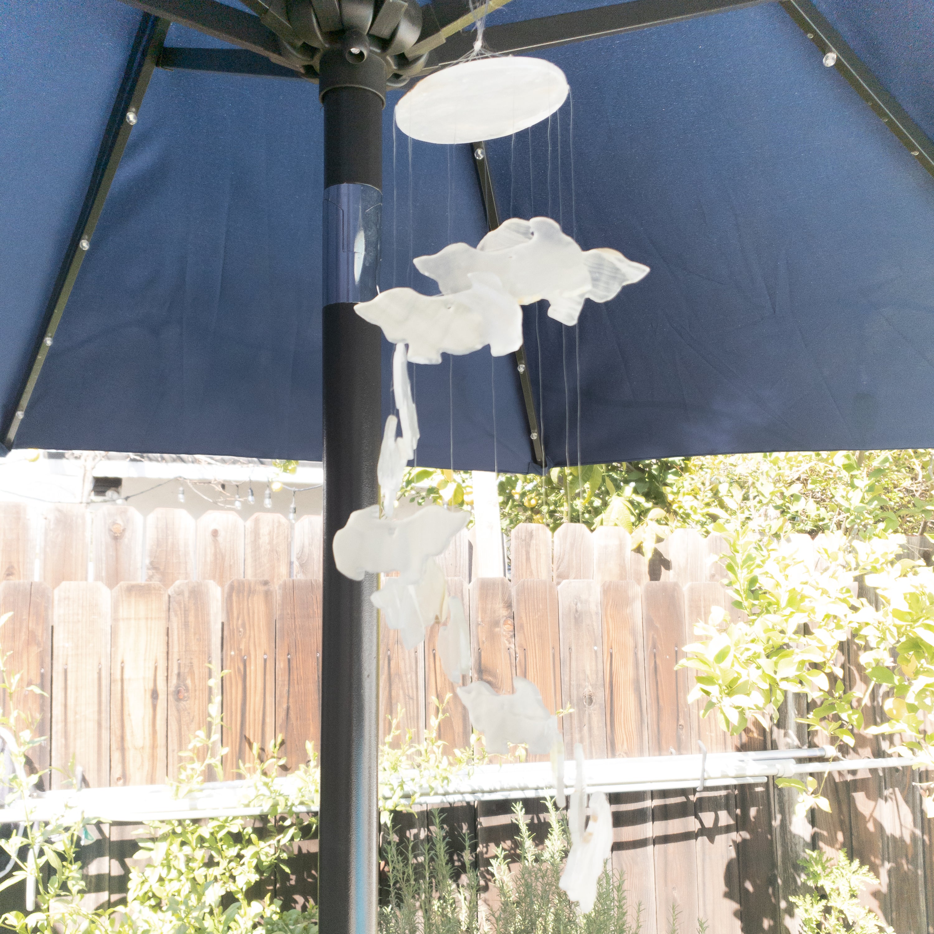 Handmade wind chime featuring cute dog shapes crafted from natural white onyx, hanging elegantly.