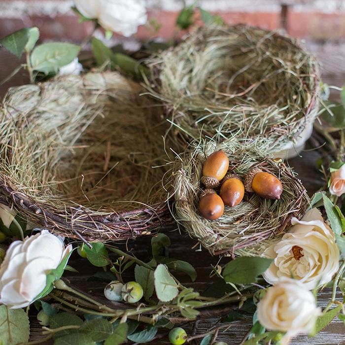 Set of 3 handmade bird's nest ornaments made from grass and willow, showcasing natural colors of brown and green.