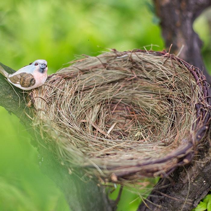 Set of 3 handmade bird's nest ornaments made from grass and willow, showcasing natural colors of brown and green.