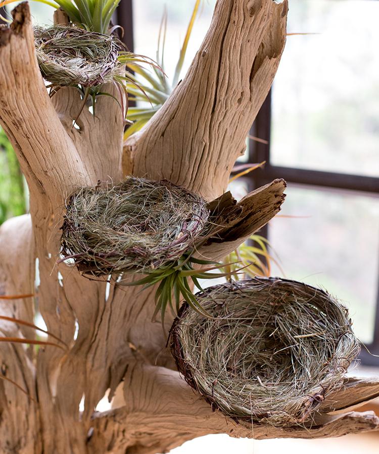 Set of 3 handmade bird's nest ornaments made from grass and willow, showcasing natural colors of brown and green.