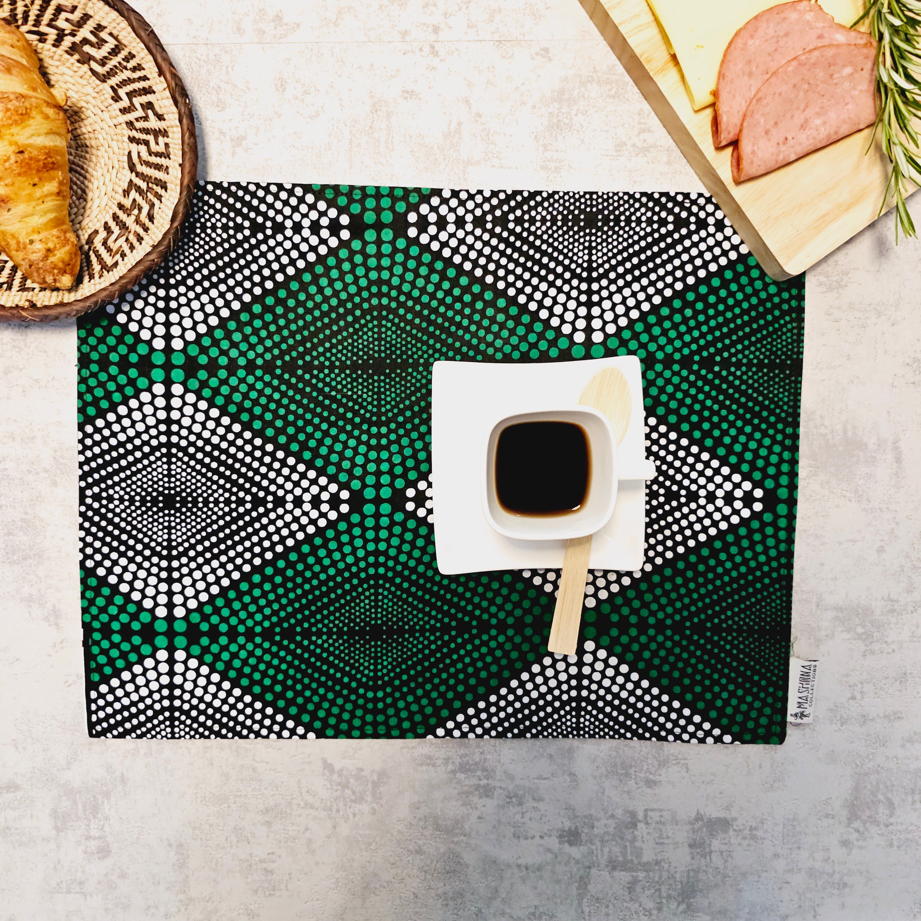 A set of four handmade placemats featuring vibrant African prints, measuring 32cm x 42cm, showcasing a bohemian-inspired design.