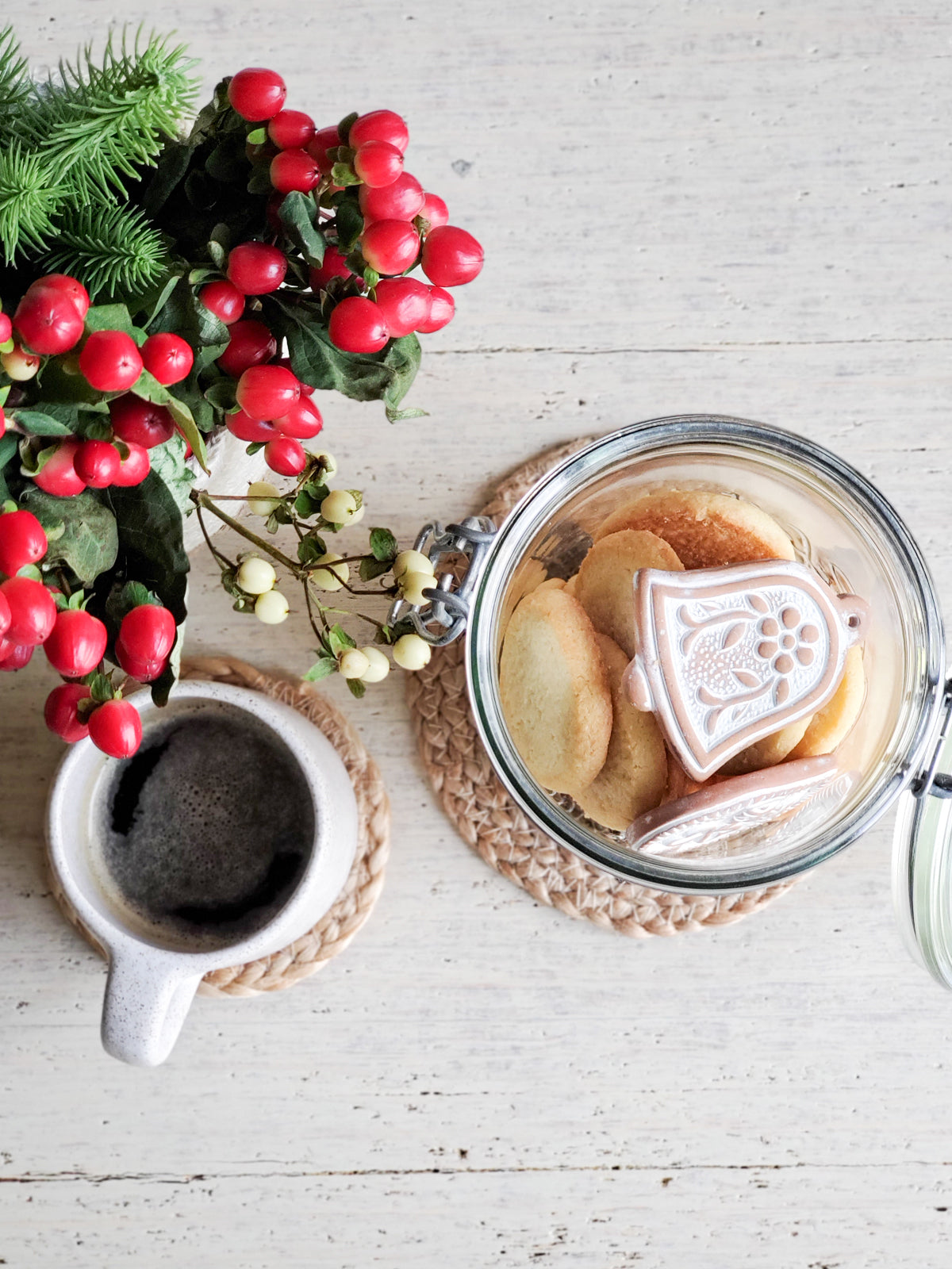 Handmade terracotta sugar saver ornament with a natural jute rope, displayed in a green drawstring pouch, perfect for holiday gifting.