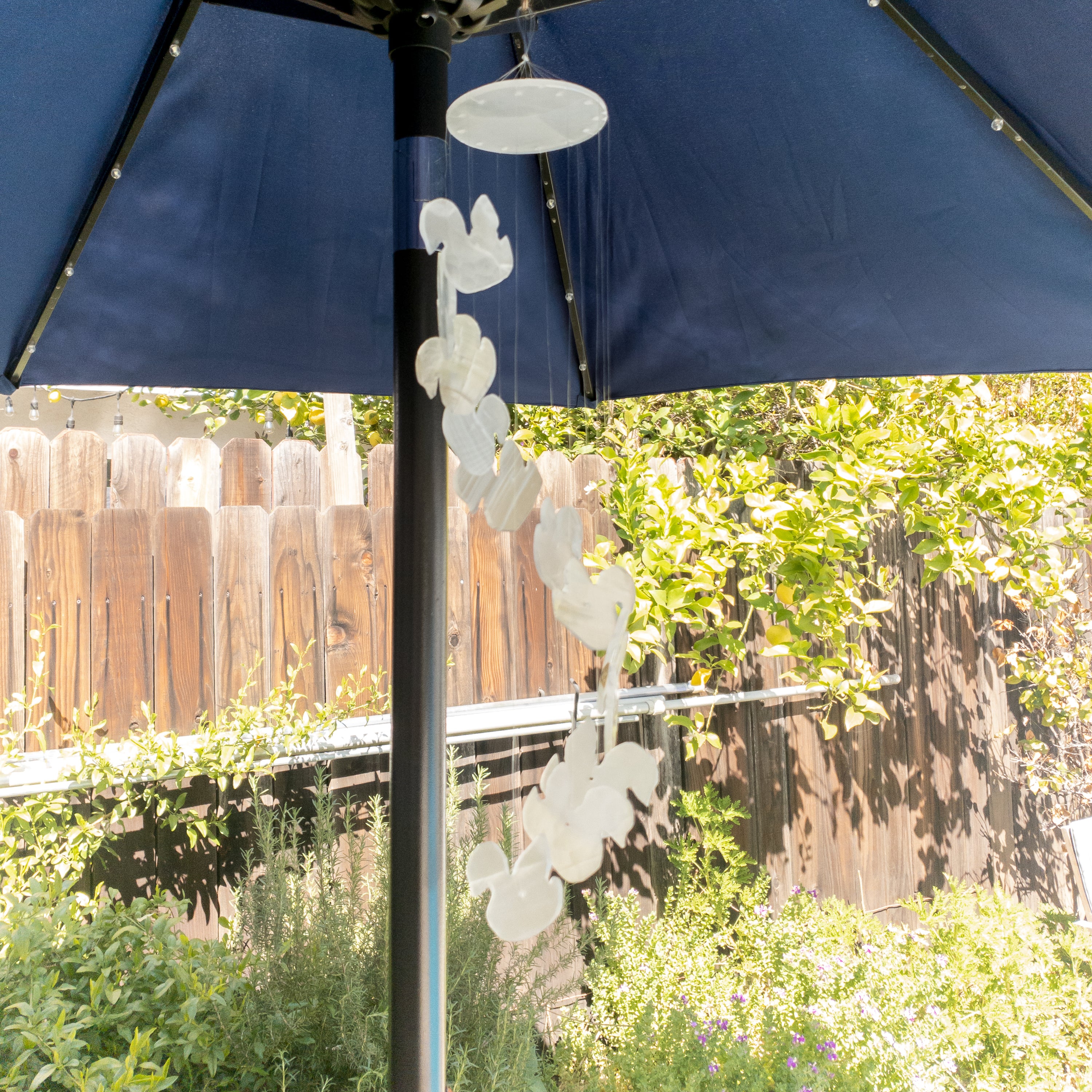 Handmade wind chime featuring elegant swan designs crafted from natural white onyx, hanging gracefully.