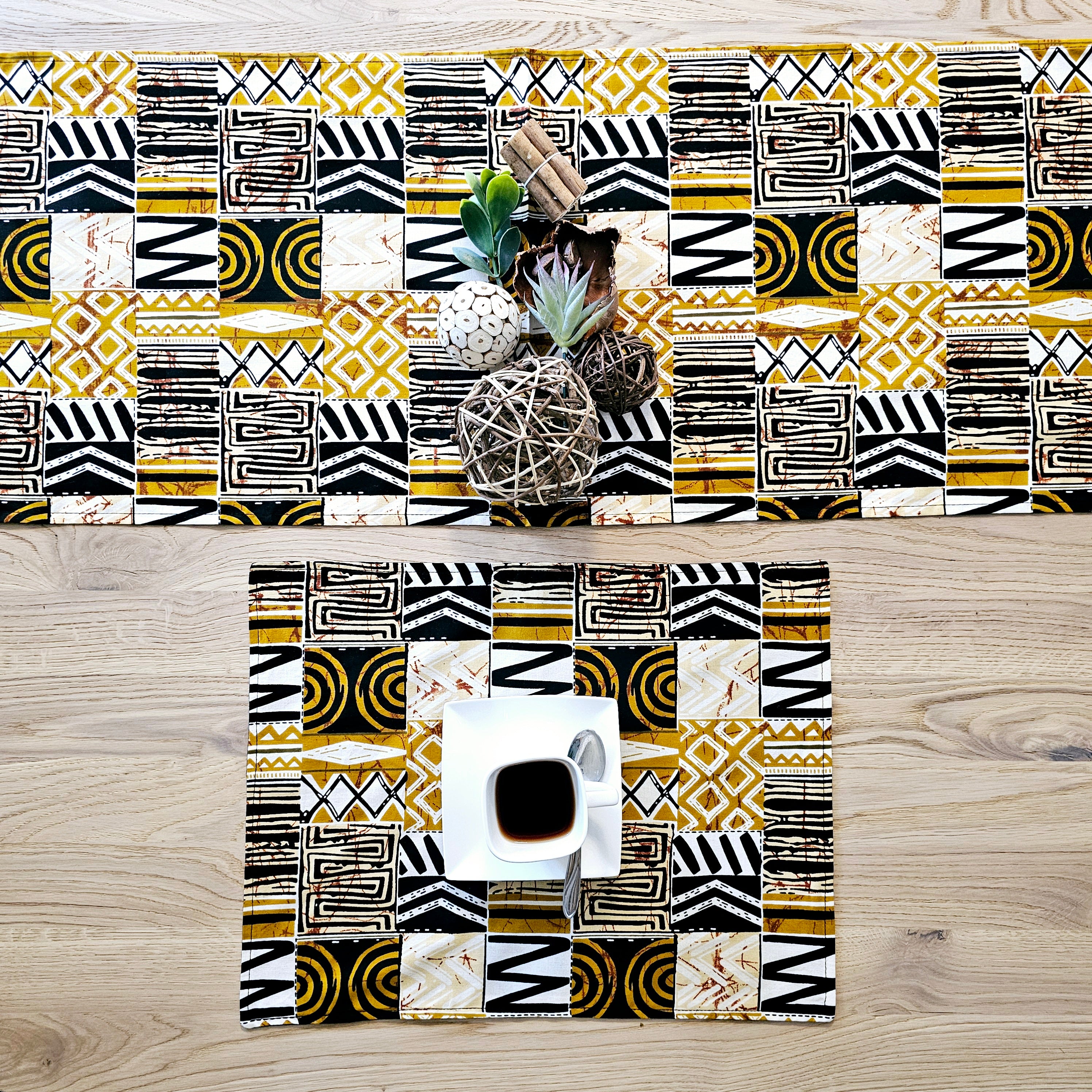 Handmade table runner and set of 8 placemats featuring vibrant African prints, perfect for dining decor.