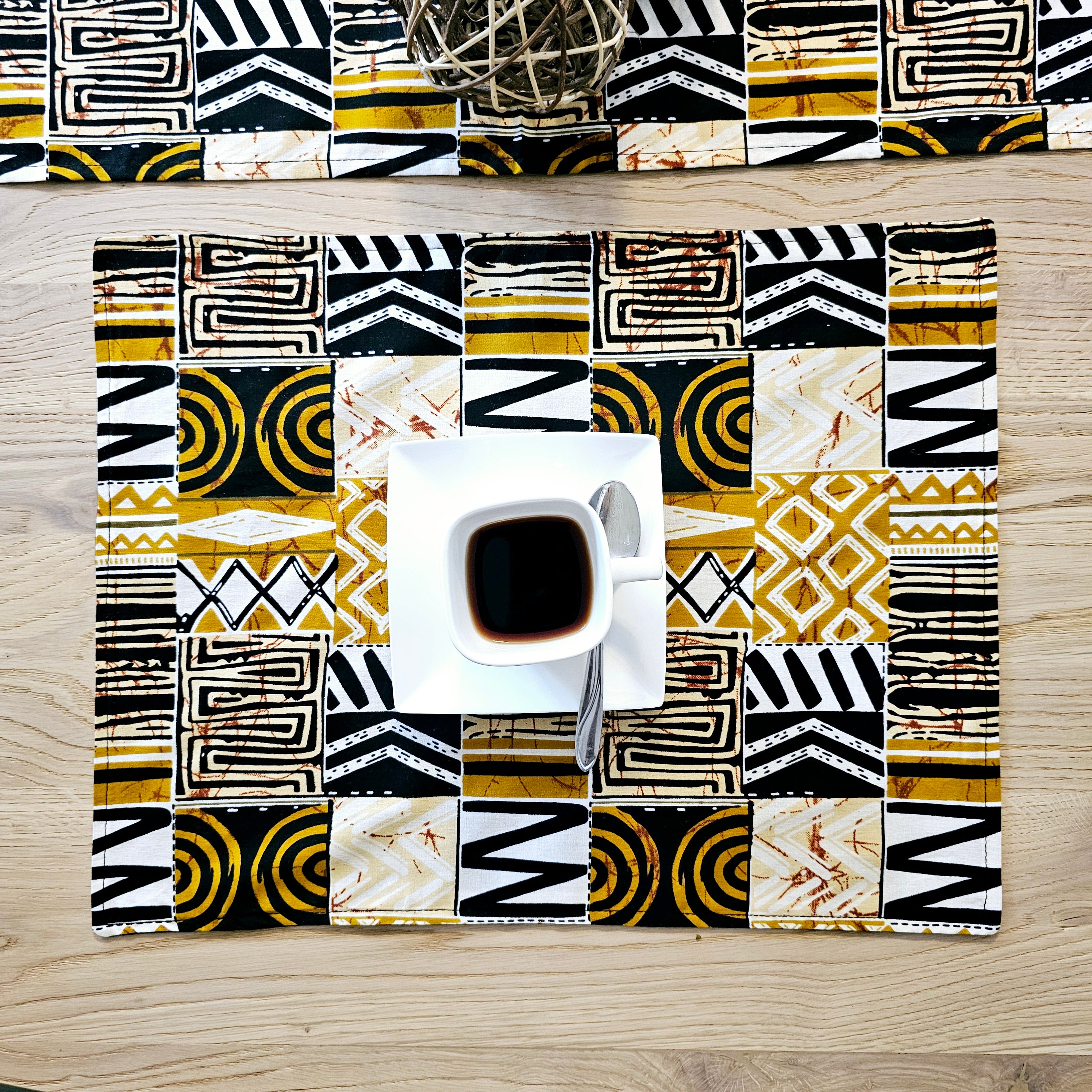 Handmade table runner and set of 8 placemats featuring vibrant African prints, perfect for dining decor.