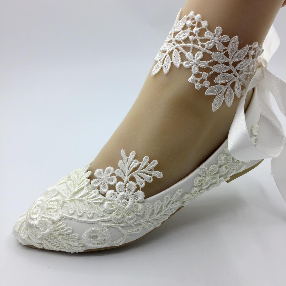 Elegant handmade white lace wedding flat shoes for brides, featuring intricate lace details and stylish embellishments.