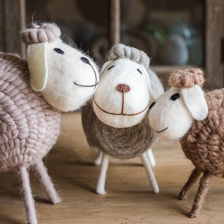 A charming set of three handmade wool sheep knick-knacks in various colors, perfect for home decor.