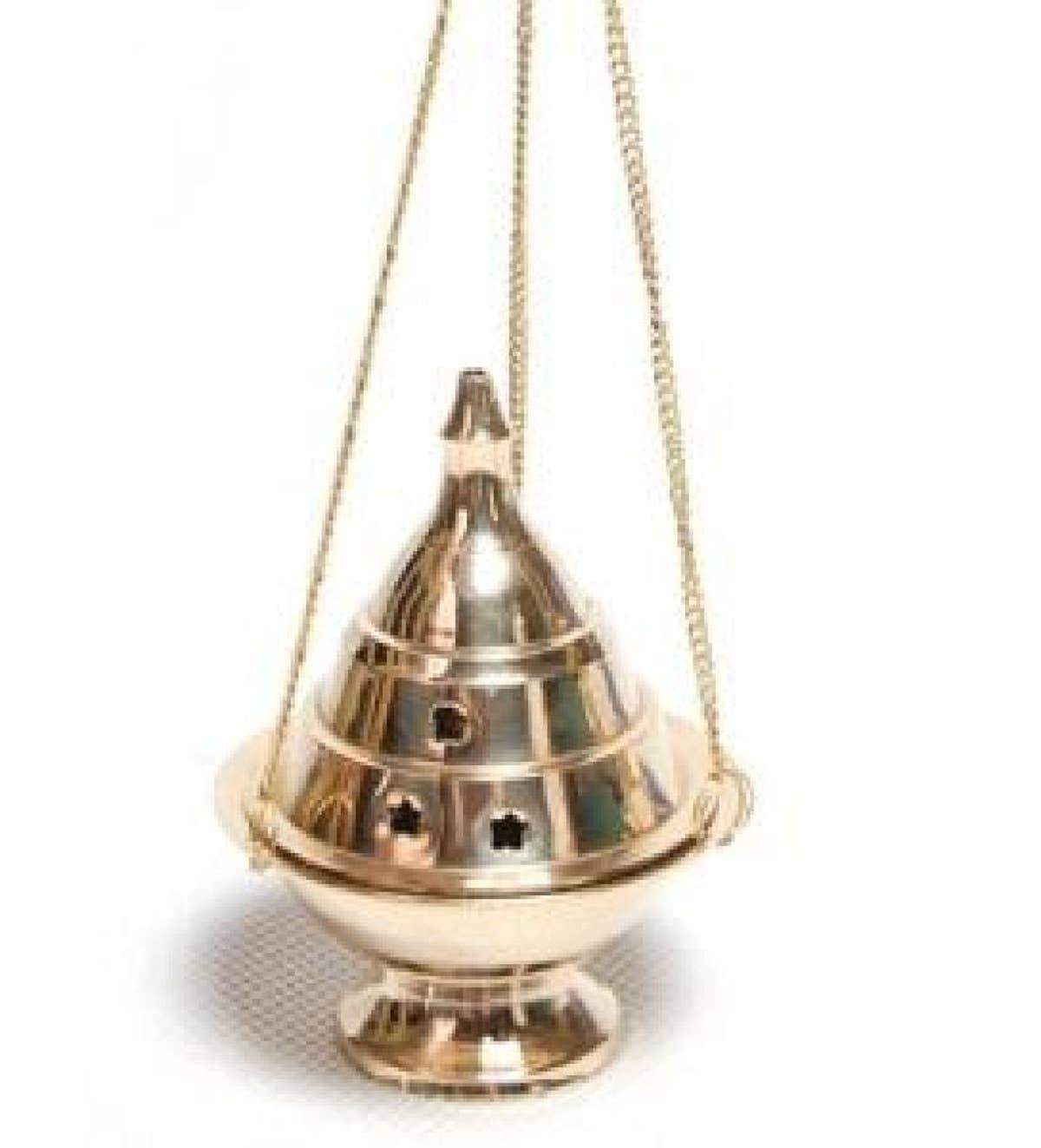 Hanging brass incense burner with clover-shaped holes, polished finish, and compact design for burning various types of incense.