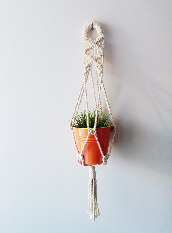 Handmade macrame plant hanger made of 100% cotton cord, measuring 31 inches long, designed to hold small planters up to 5 inches in diameter.