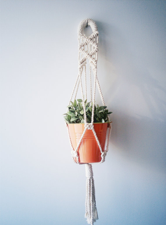 Handmade macrame plant hanger made of 100% cotton cord, measuring 31 inches long, designed to hold small planters up to 5 inches in diameter.