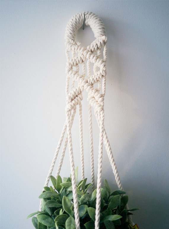 Handmade macrame plant hanger made of 100% cotton cord, measuring 31 inches long, designed to hold small planters up to 5 inches in diameter.