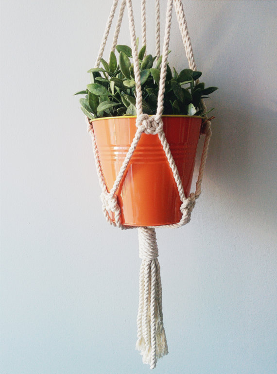 Handmade macrame plant hanger made of 100% cotton cord, measuring 31 inches long, designed to hold small planters up to 5 inches in diameter.