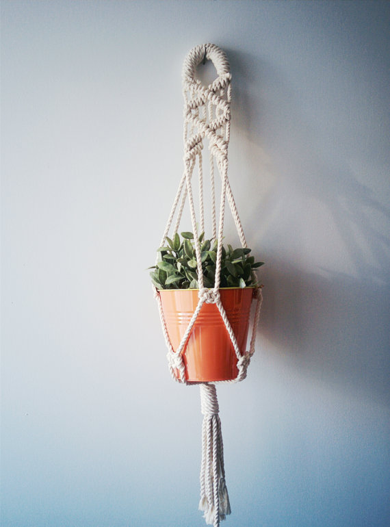 Handmade macrame plant hanger made of 100% cotton cord, measuring 31 inches long, designed to hold small planters up to 5 inches in diameter.