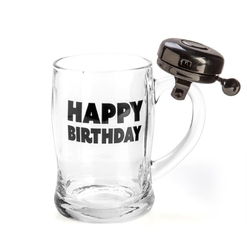 A glass beer mug with a black bell attached to the handle, featuring bold 'Happy Birthday' lettering.