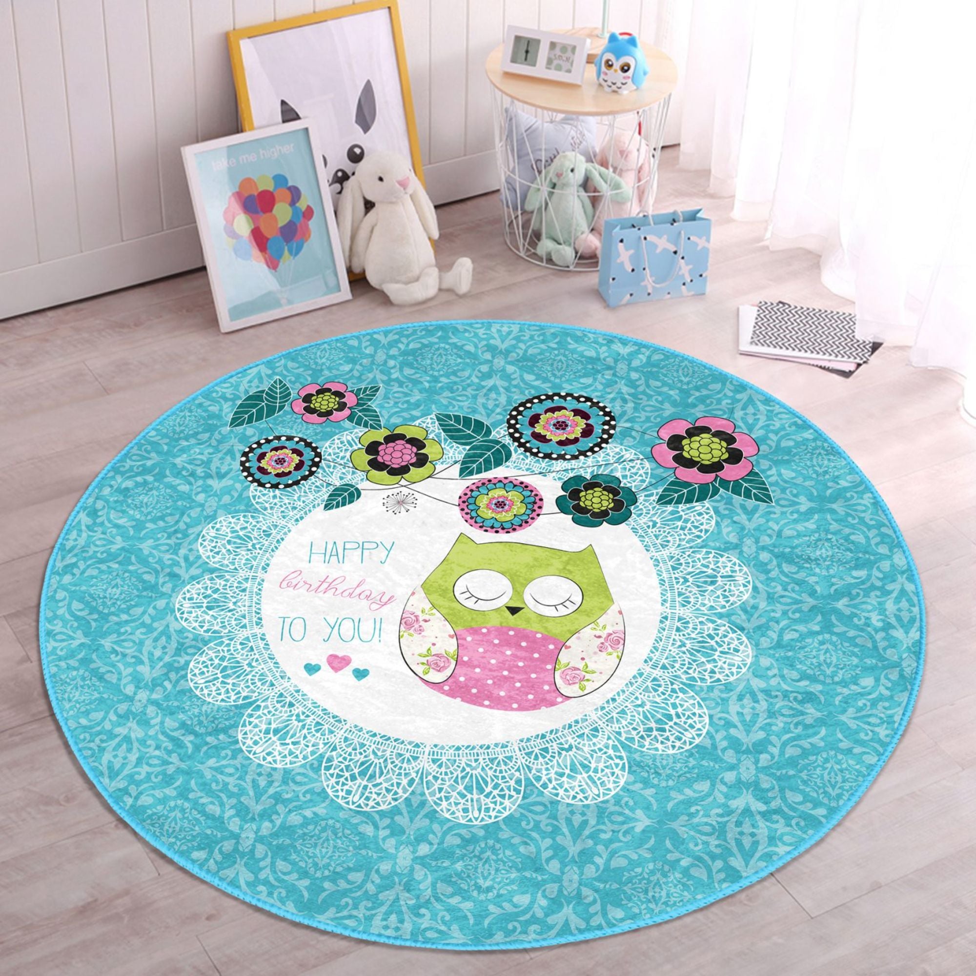 A colorful round rug featuring a happy birthday owl pattern, perfect for kids' rooms, showcasing vibrant colors and soft velvet texture.