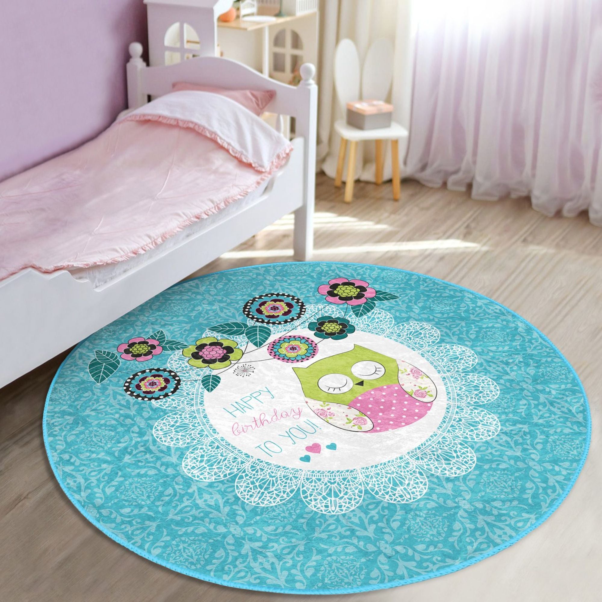 A colorful round rug featuring a happy birthday owl pattern, perfect for kids' rooms, showcasing vibrant colors and soft velvet texture.