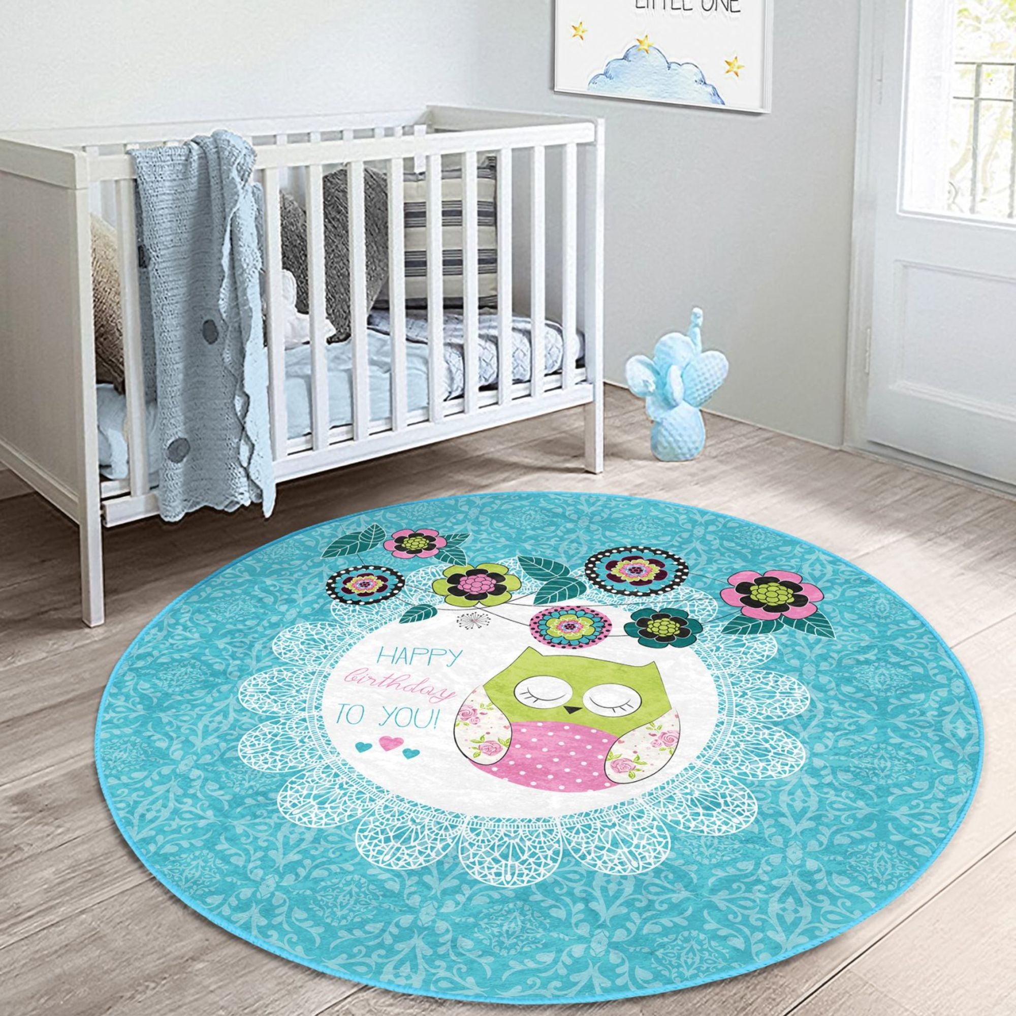 A colorful round rug featuring a happy birthday owl pattern, perfect for kids' rooms, showcasing vibrant colors and soft velvet texture.