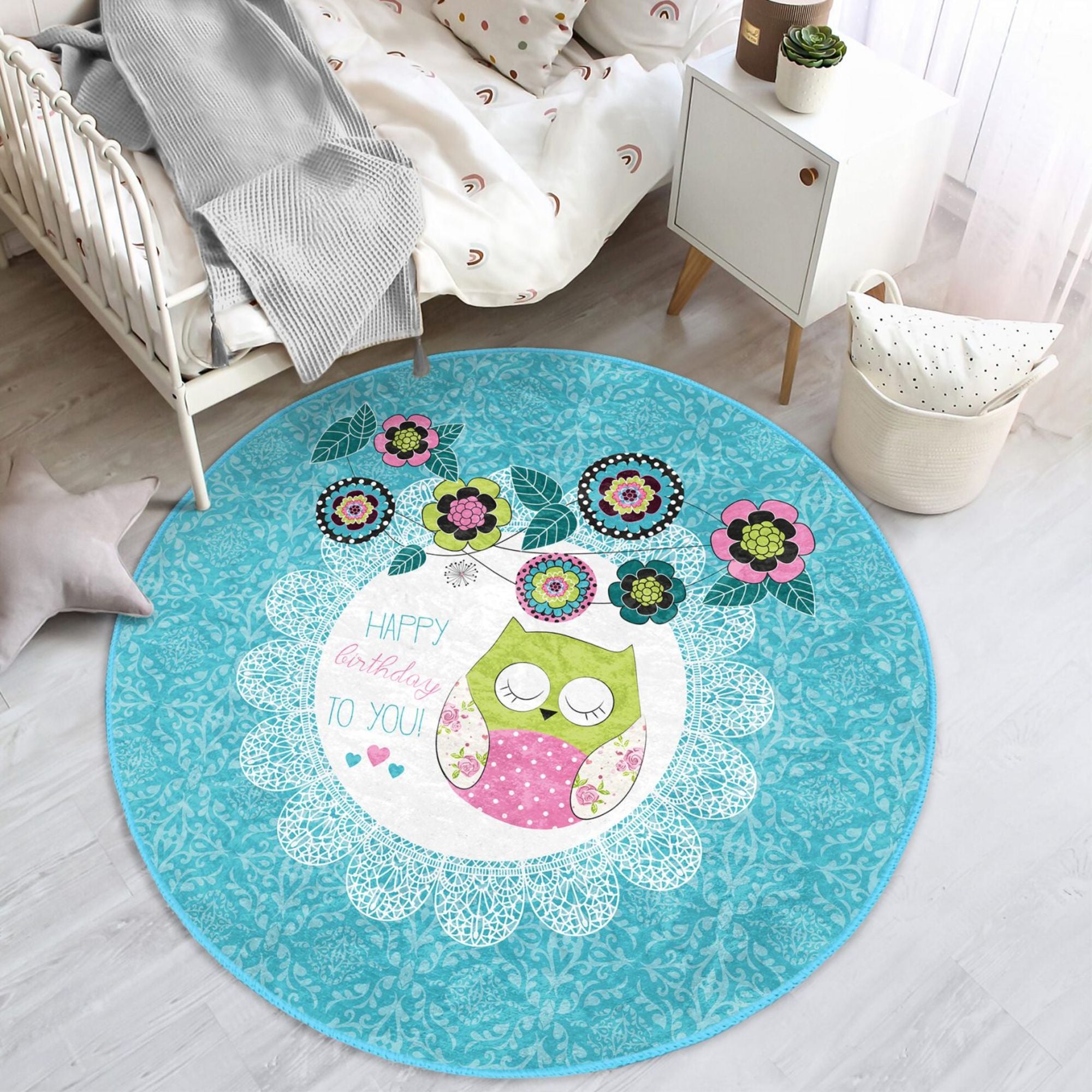 A colorful round rug featuring a happy birthday owl pattern, perfect for kids' rooms, showcasing vibrant colors and soft velvet texture.