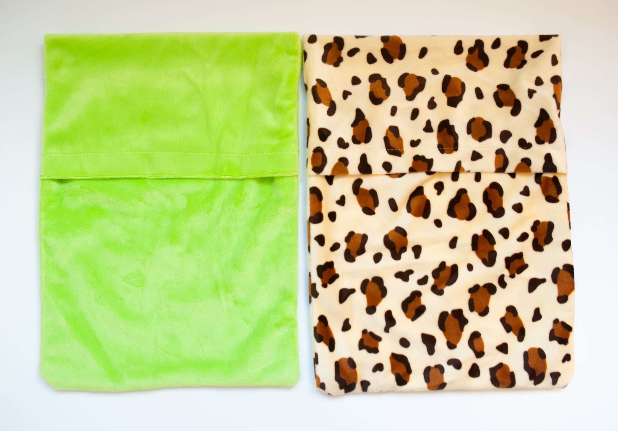 Happy Heat Hot Water Bottle Cover set in green animal print, featuring soft fleece material for comfort.