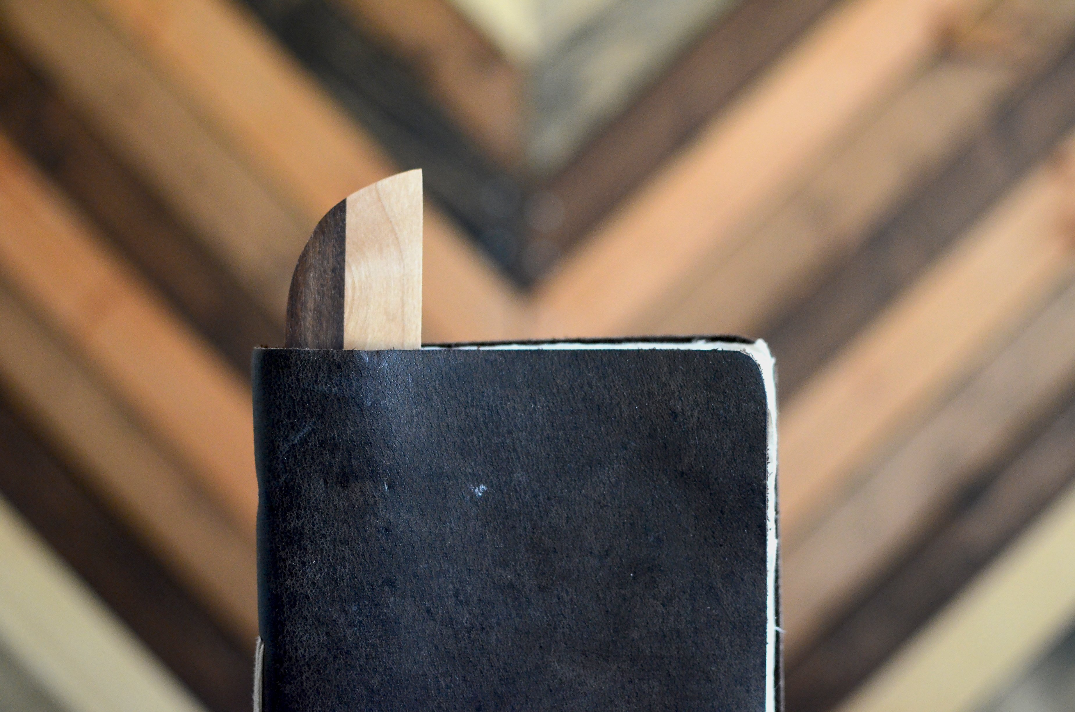 A beautifully handcrafted hardwood bookmark made from Black Walnut, White Maple, and Cherry, showcasing its natural grain and warm finish.