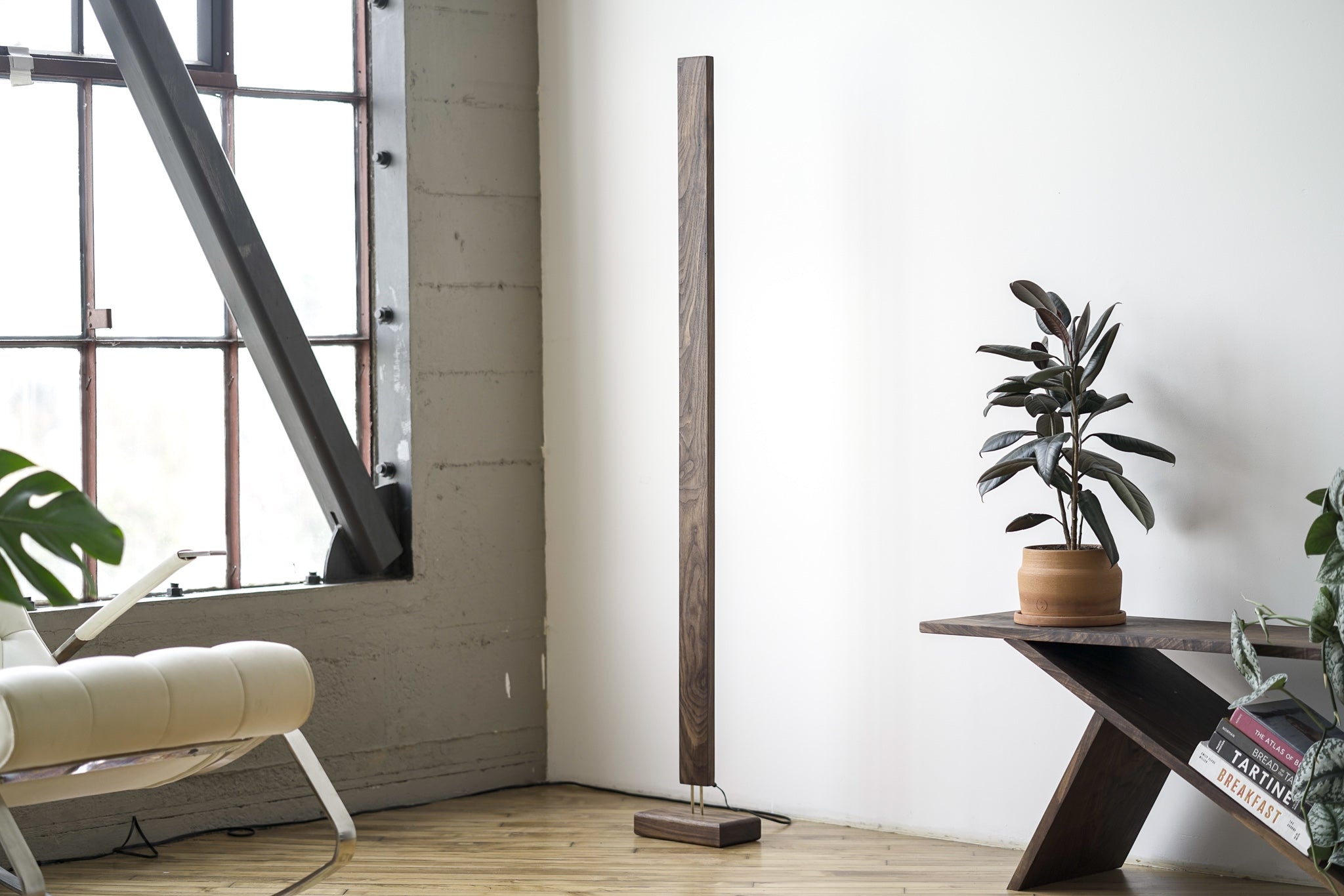 A sleek Hardwood LED Color Floor Lamp made from sustainably sourced Black Walnut and White Maple, featuring a slim design and colorful RGB lighting.