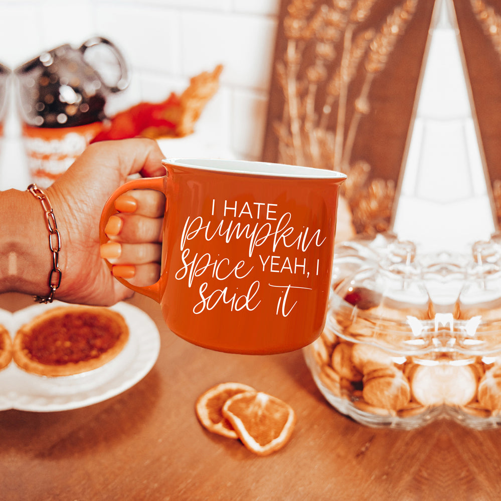 Hate Pumpkin Mug in vibrant orange with white lettering, featuring the phrase 'I hate pumpkin spice, yeah I said it' on both sides.