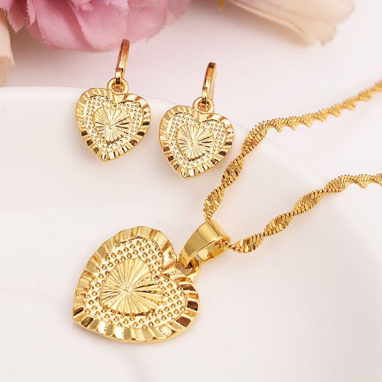 Elegant Heart Pendant Jewelry Set featuring a 14K gold-filled necklace and matching earrings, beautifully displayed in a velvet jewelry bag.