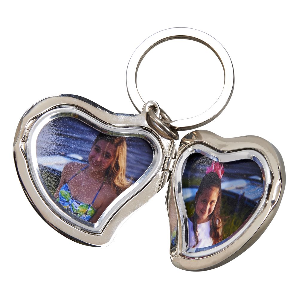 Heart shaped locket keychain with two photo slots and a shiny silver finish, elegantly designed for personal use or gifting.