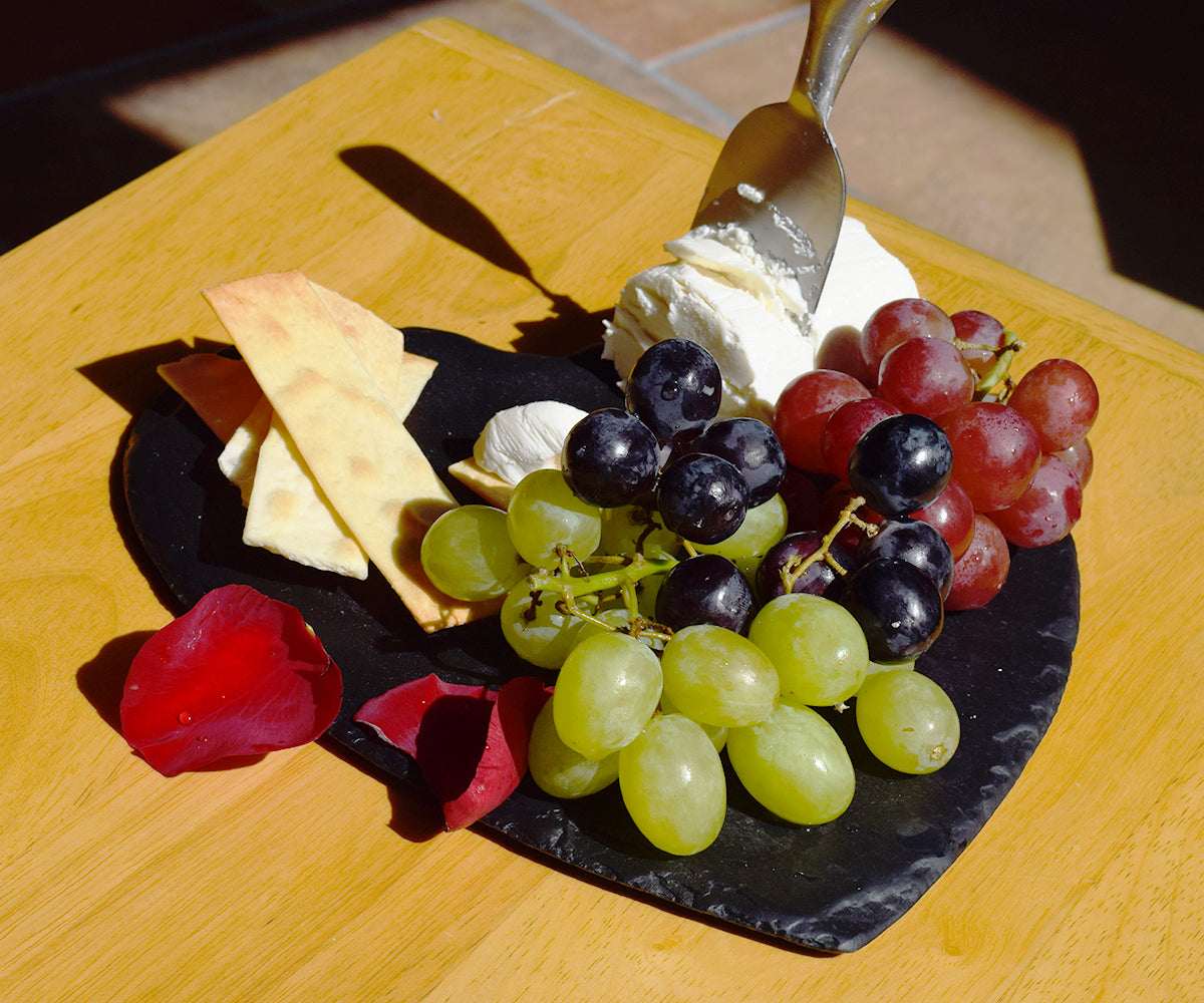 A heart-shaped slate plate, perfect for holding drinks or displaying beauty products, measuring 9 inches in diameter.