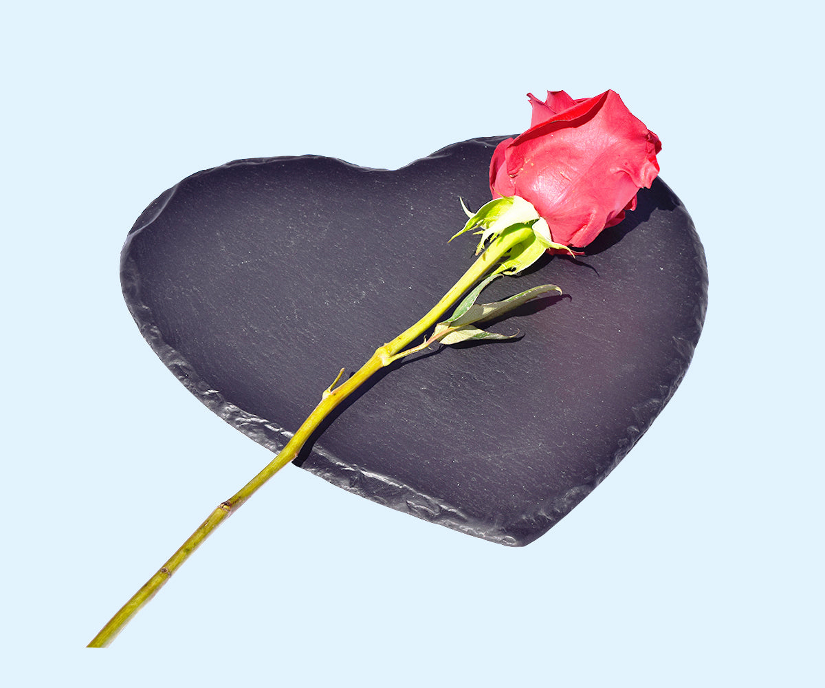 A heart-shaped slate plate, perfect for holding drinks or displaying beauty products, measuring 9 inches in diameter.