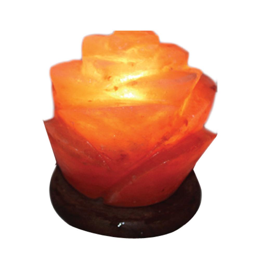 A beautifully carved Himalayan Pink Salt Lamp emitting a warm glow, showcasing its unique shape and natural texture.