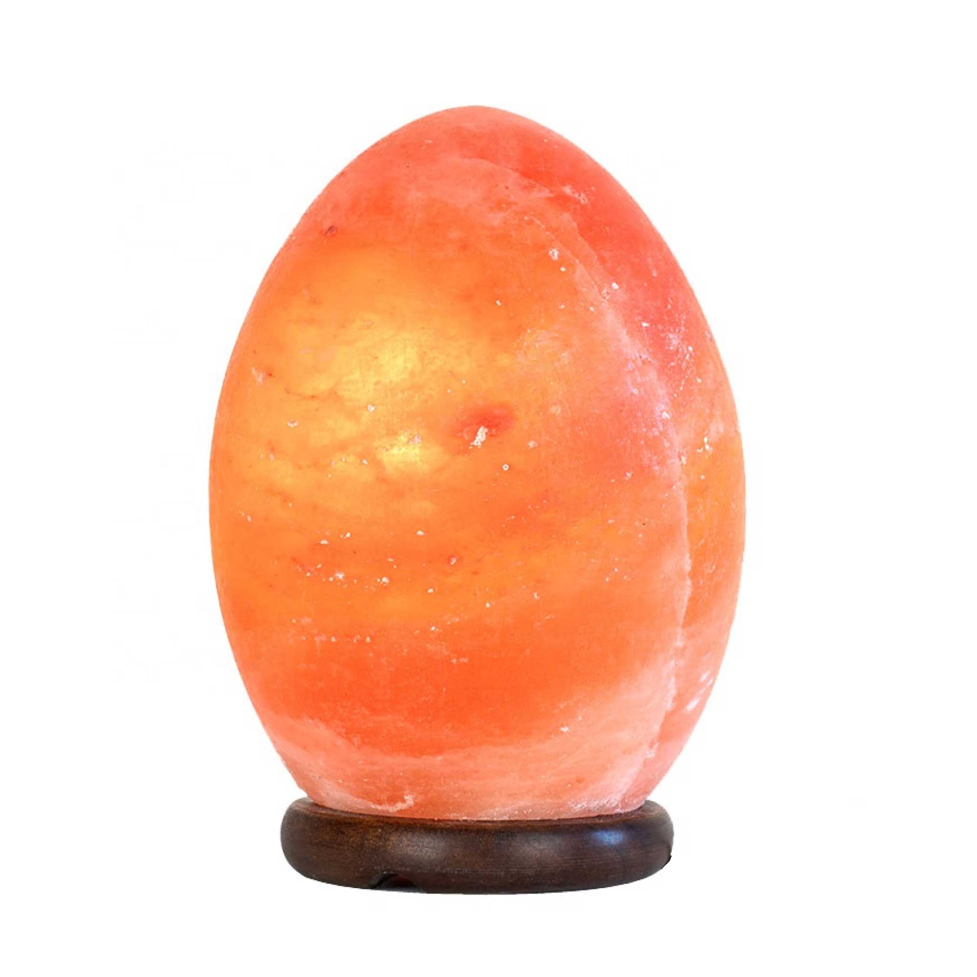 A beautifully carved Himalayan Pink Salt Lamp emitting a warm glow, showcasing its unique shape and natural texture.