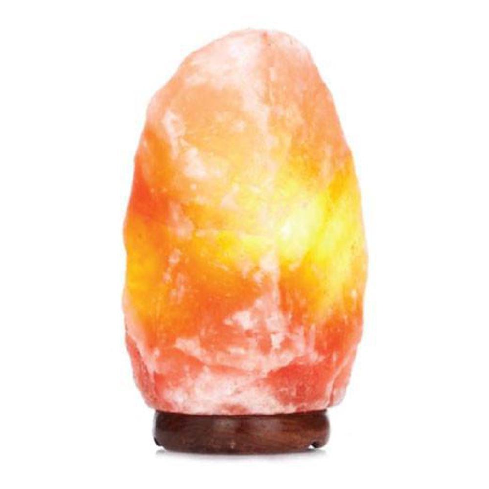 A beautifully carved Himalayan Pink Salt Lamp emitting a warm glow, showcasing its unique shape and natural texture.