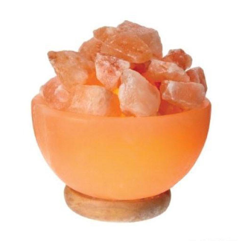 A beautifully carved Himalayan Pink Salt Lamp emitting a warm glow, showcasing its unique shape and natural texture.