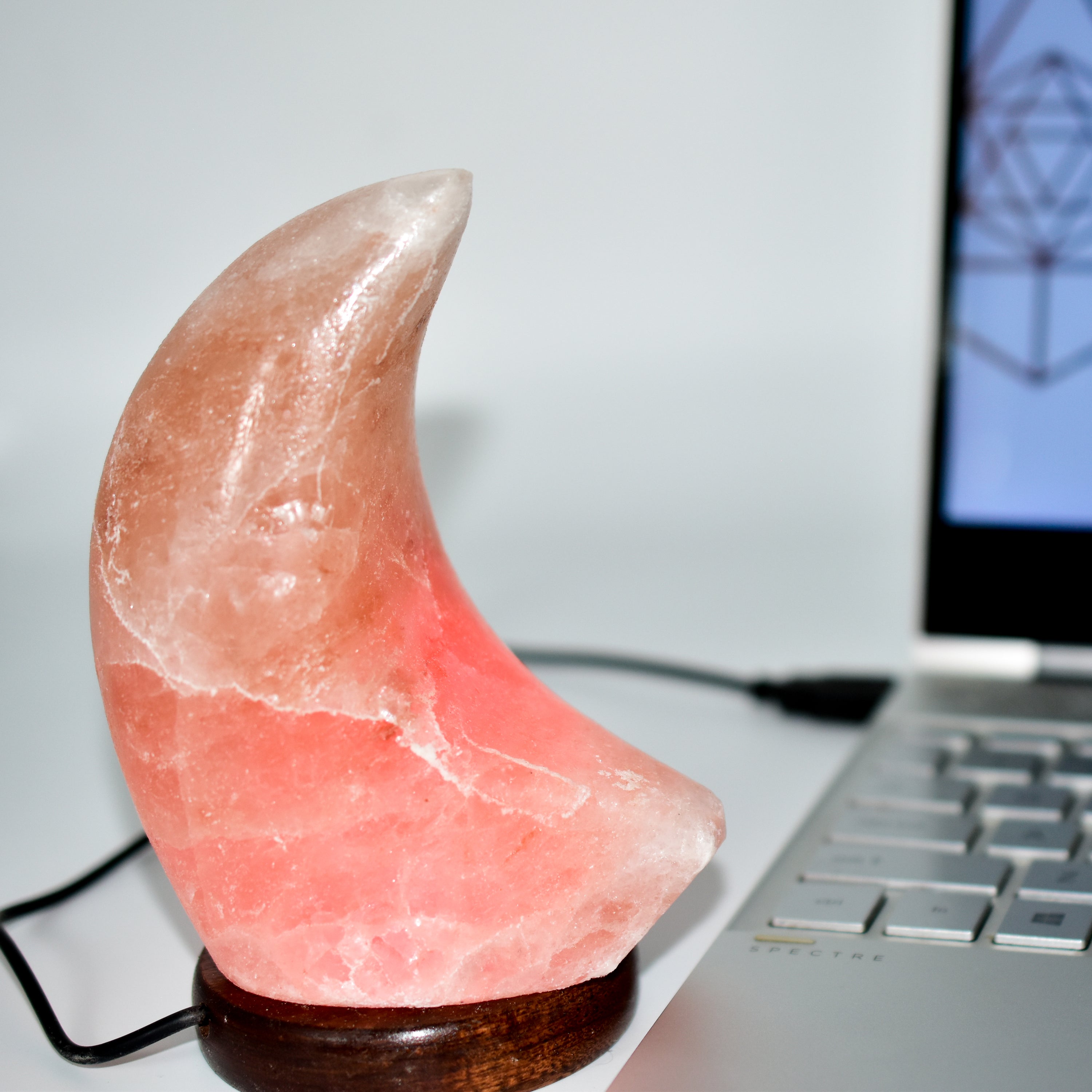 A beautifully handcrafted Himalayan Salt Moon Lamp glowing softly in various colors, showcasing its unique texture and design.