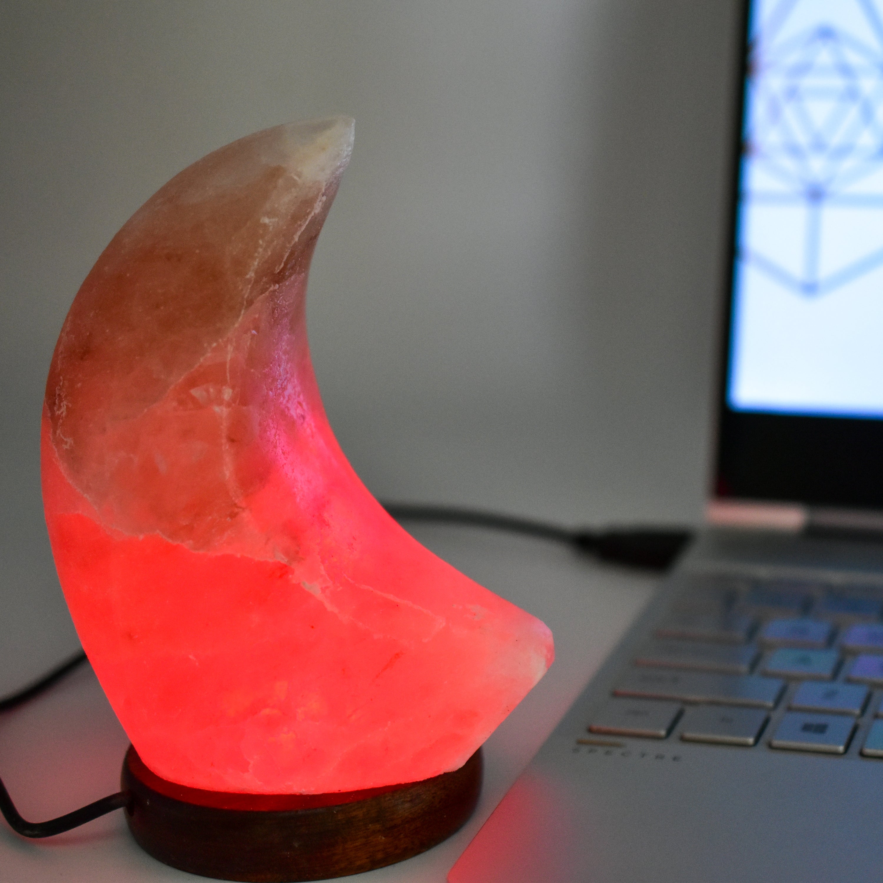 A beautifully handcrafted Himalayan Salt Moon Lamp glowing softly in various colors, showcasing its unique texture and design.