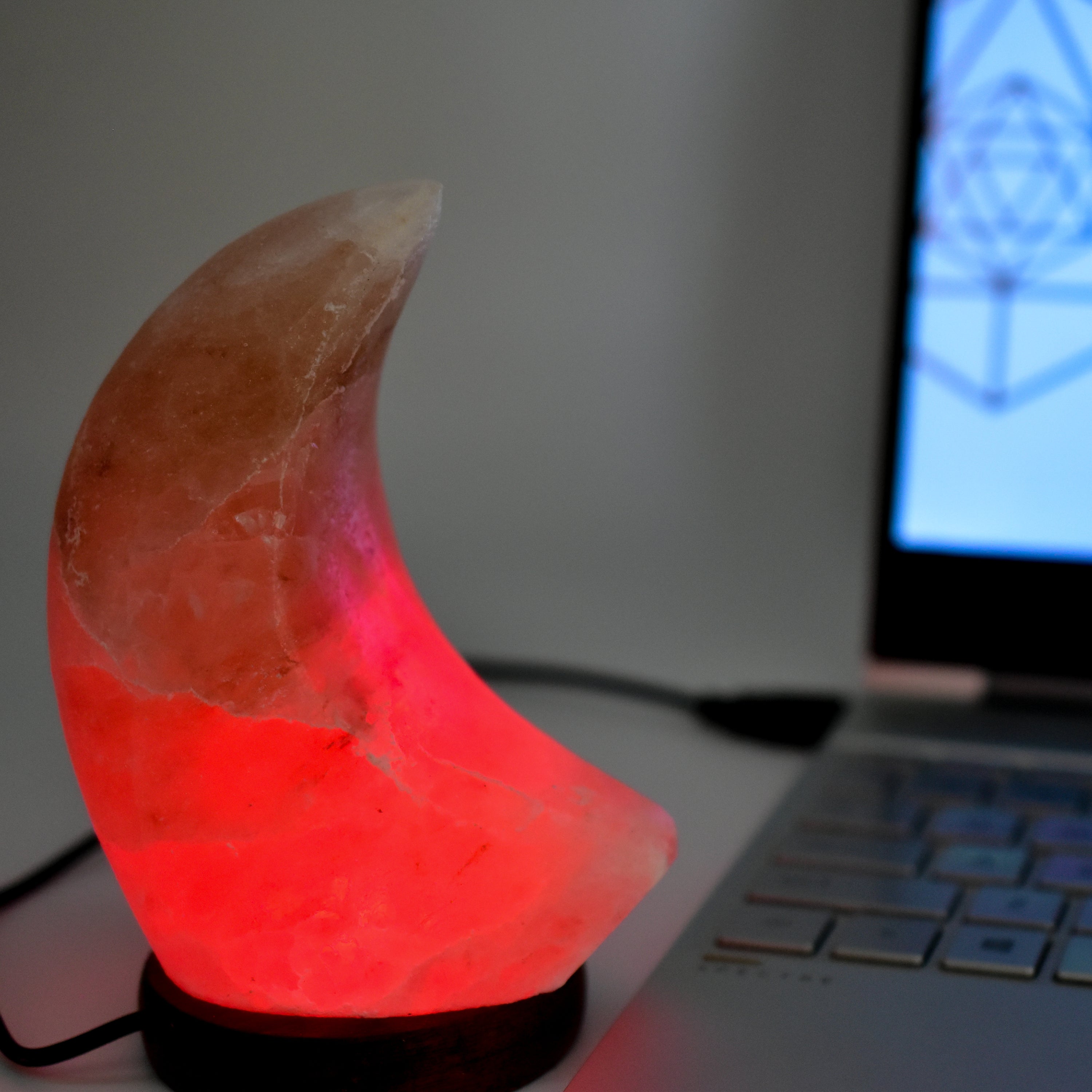 A beautifully handcrafted Himalayan Salt Moon Lamp glowing softly in various colors, showcasing its unique texture and design.