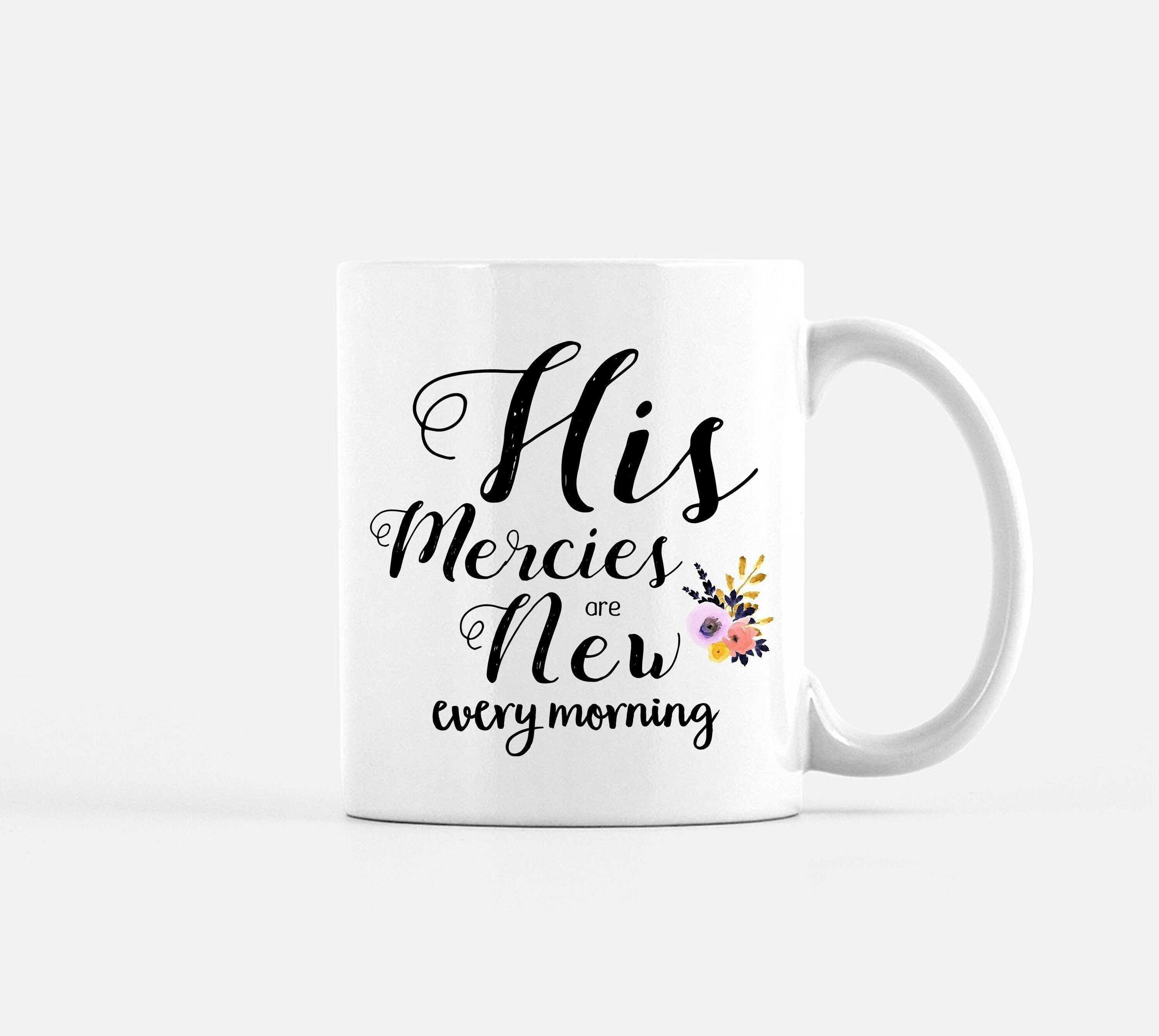 White coffee mug with hand-lettered scripture 'His Mercies are New Every Morning' printed on both sides, showcasing an inspirational design.