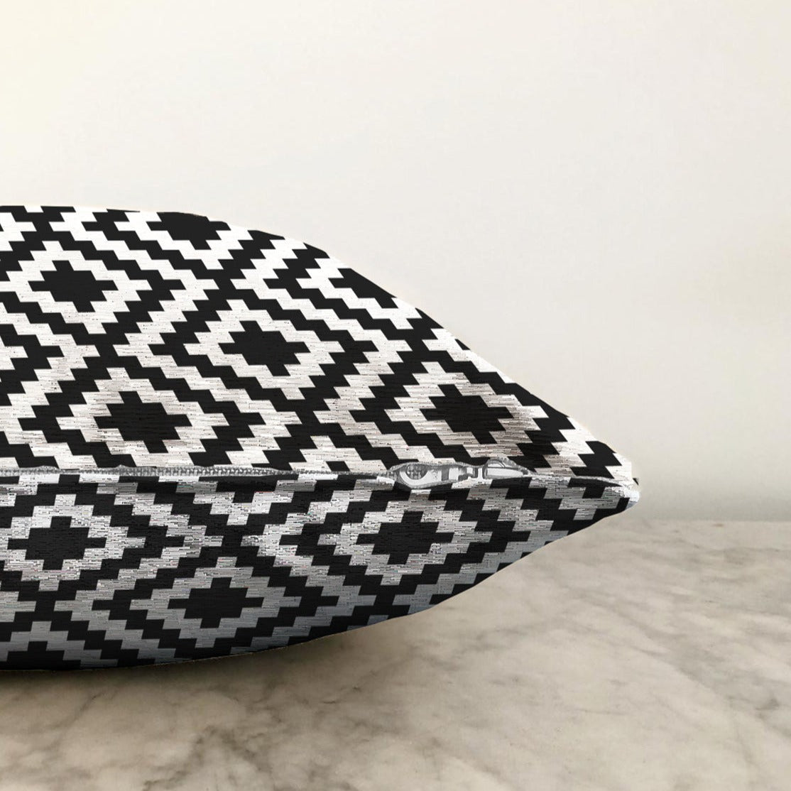 Stylish black and white decorative throw pillow cover with zipper, suitable for indoor and outdoor use.