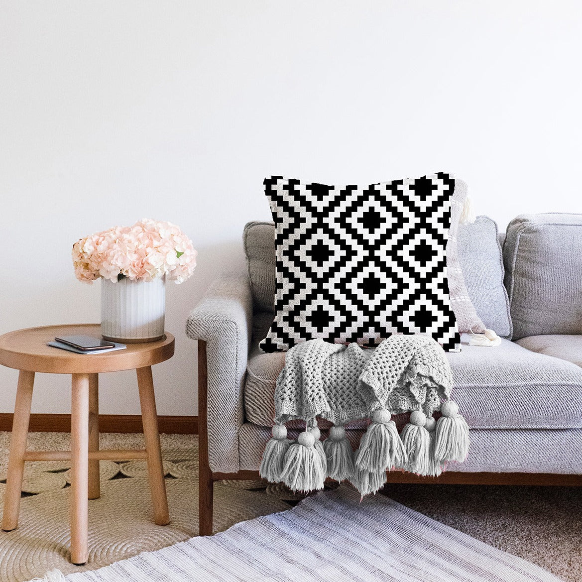 Stylish black and white decorative throw pillow cover with zipper, suitable for indoor and outdoor use.