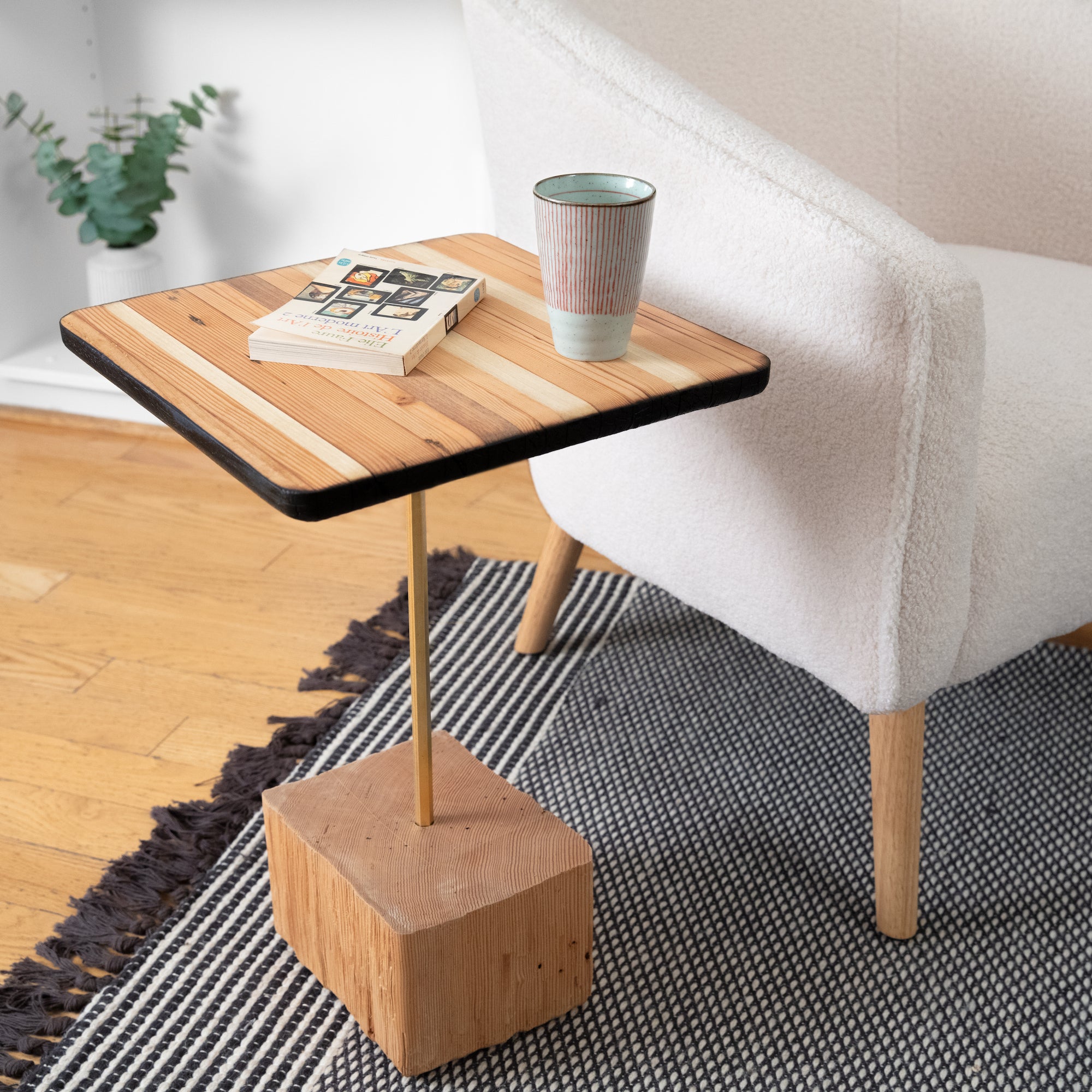 Home Slice side table featuring a unique hexagon brass leg and torched wood finish, perfect for modern interiors.