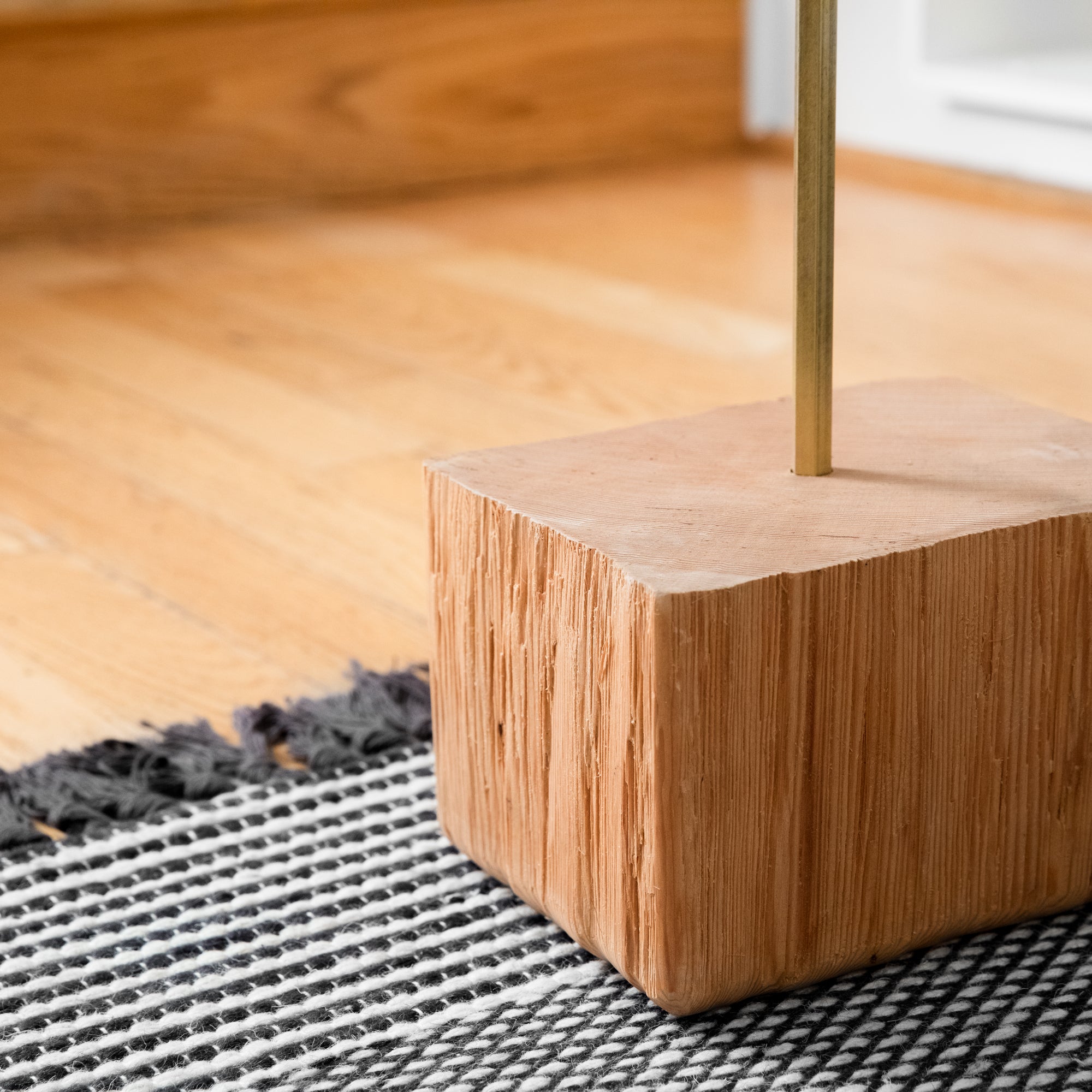 Home Slice side table featuring a unique hexagon brass leg and torched wood finish, perfect for modern interiors.