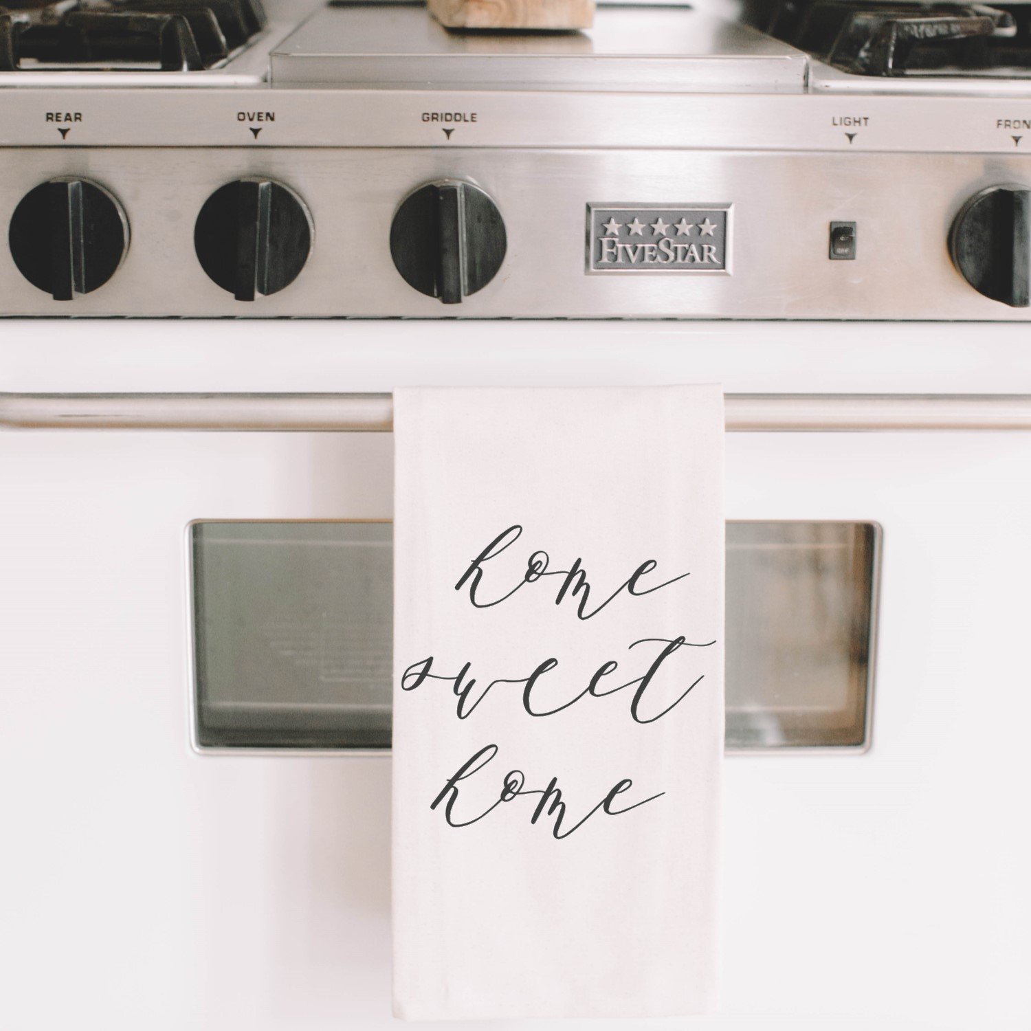 Home Sweet Home Kitchen Towel featuring elegant calligraphy design by Alyssa Thiel, made from 100% organic cotton in white and natural colors.