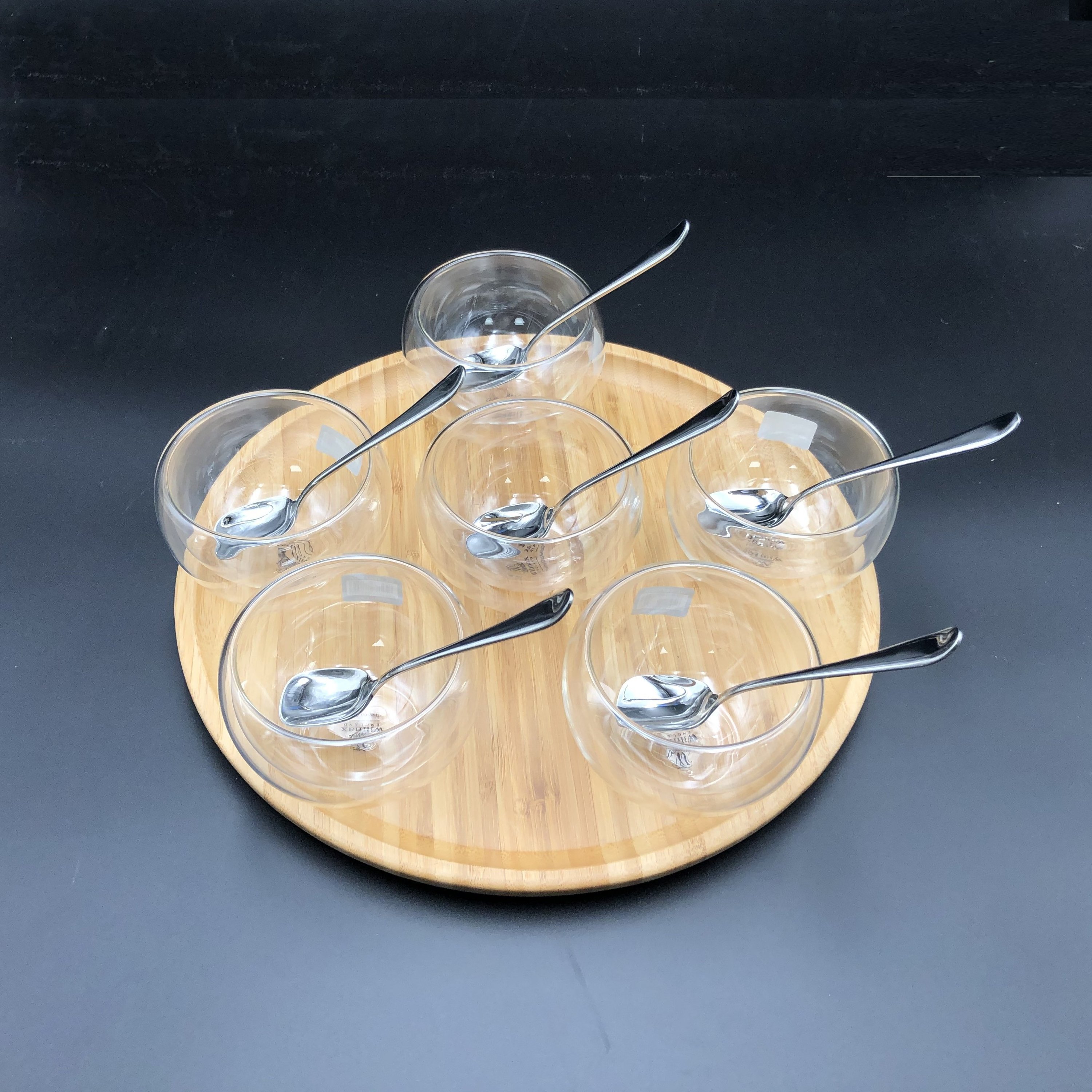 Ice-Cream Presentation Set featuring 6 double-walled bowls, stainless steel spoons, and a bamboo platter, elegantly arranged for serving desserts.