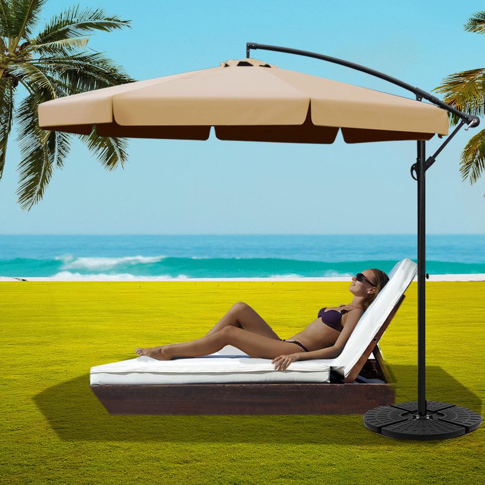 Instahut 3M Cantilever Outdoor Umbrella with beige fabric and sturdy black base, perfect for outdoor relaxation.